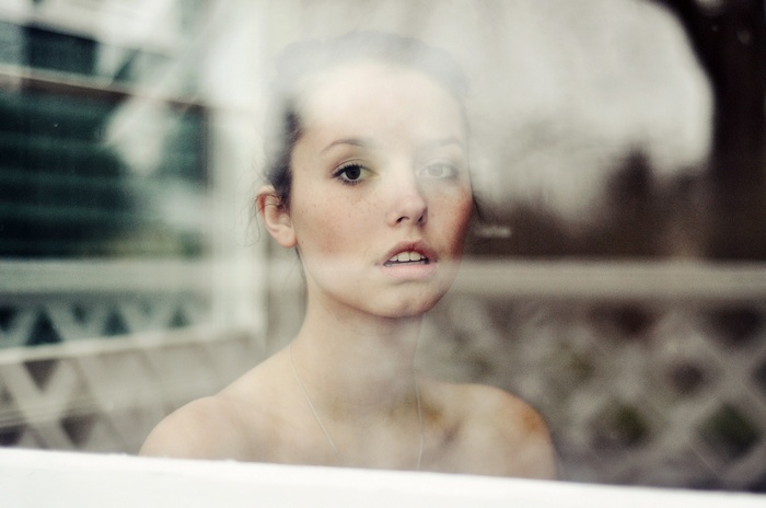 Young woman looking out a window