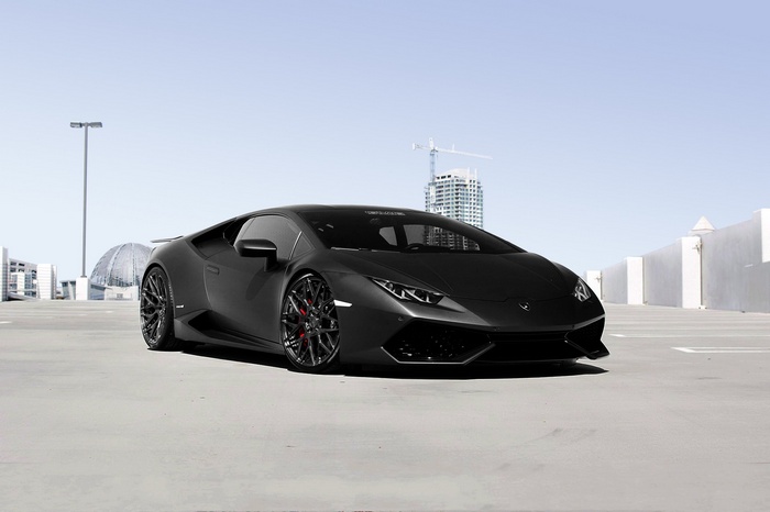 Matte black Lamborghini Huracan in a parking lot