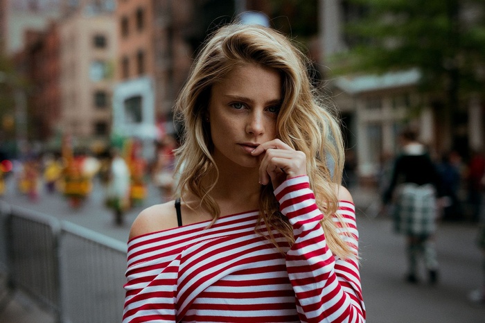 Allison Holton posing in a red and white striped shirt