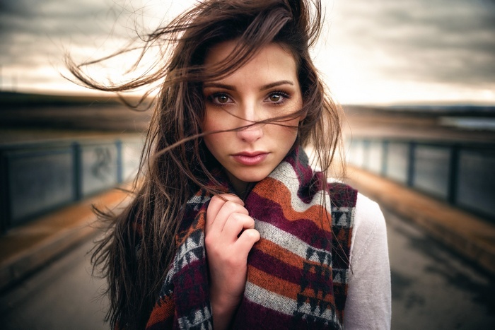 Woman with windblown hair and scarf