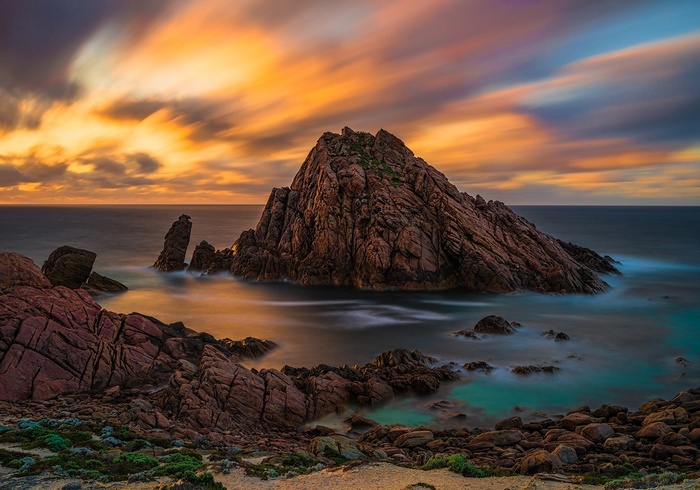 Rocky coastline with dramatic sunset sky