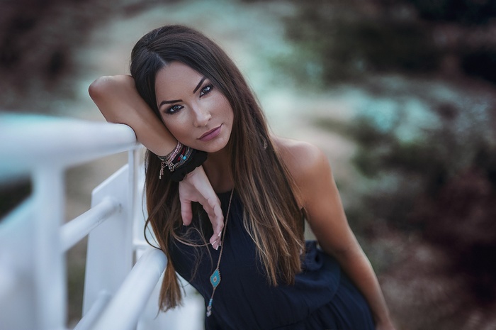 Portrait of a woman with long brown hair outdoors