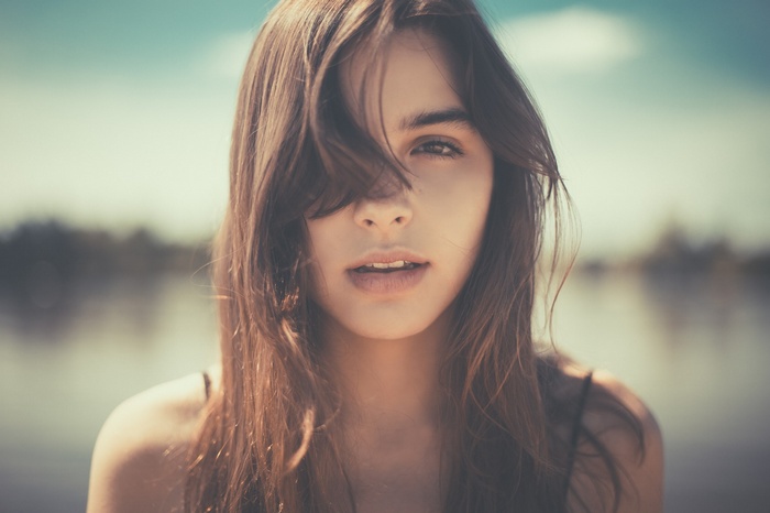 Woman with hair in face looking at viewer