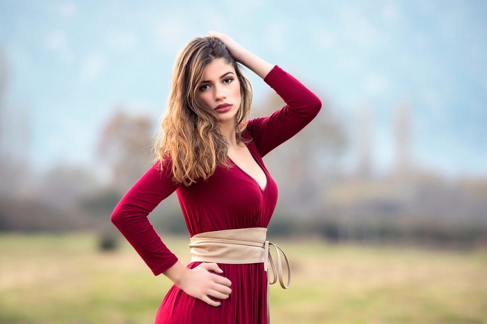 Woman in a red dress with a sash