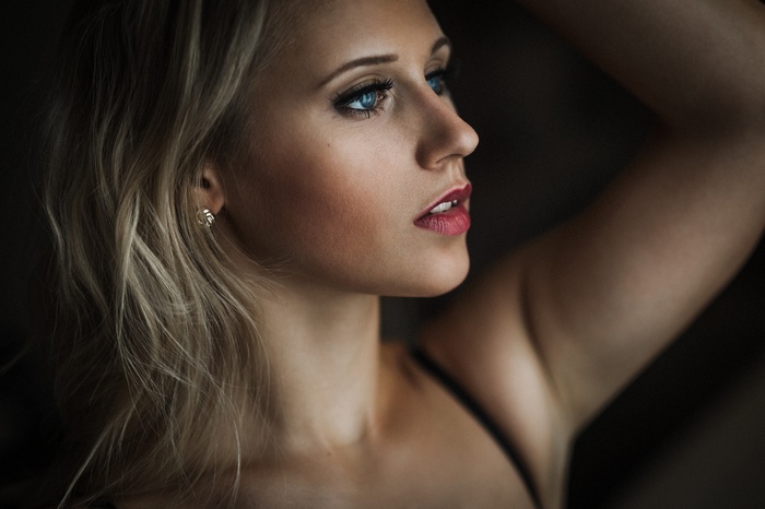 Woman with blonde hair and blue eyes looking away