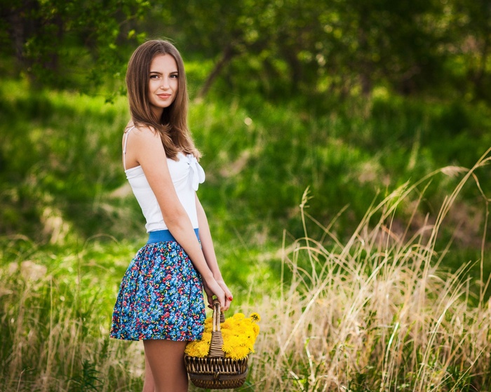Woman holding a basket of yellow flowers