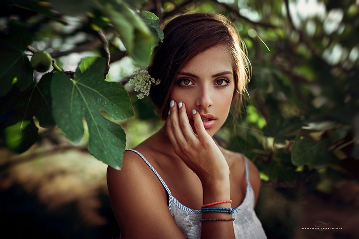 Portrait of a woman with hand on face outdoors