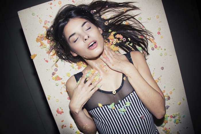 Woman lying on back with cereal