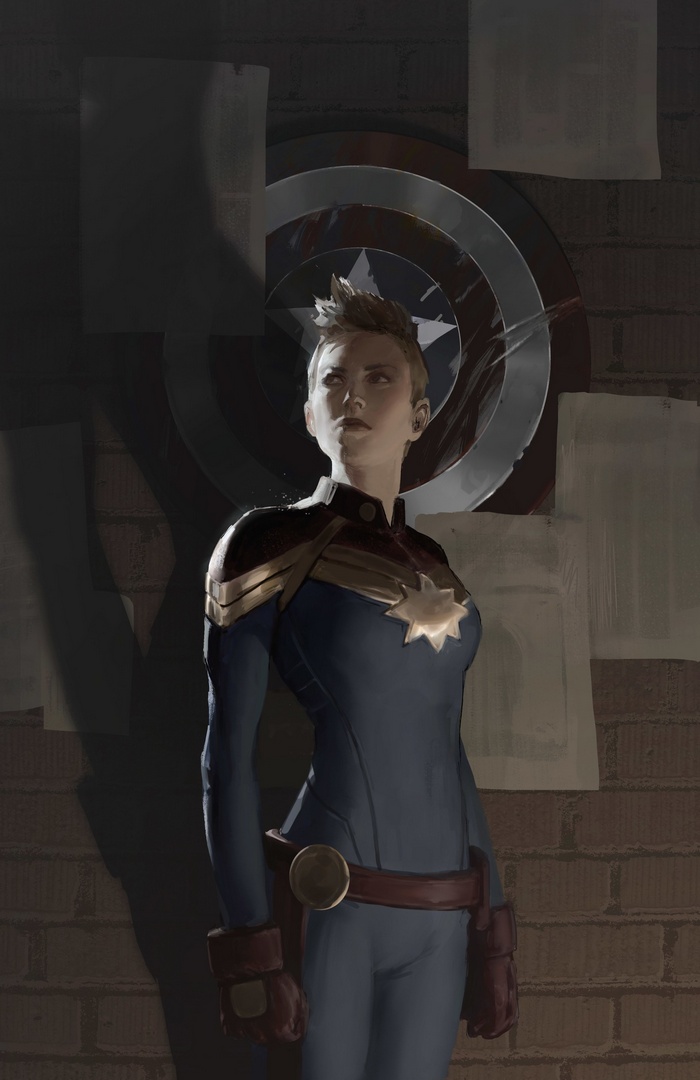 Captain Marvel in front of Captain America's shield