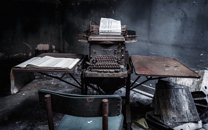 Abandoned Burroughs typewriter in a derelict room