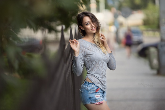 women, women outdoors, smiling, portrait, fence, jean shorts, blonde