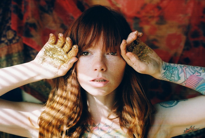 Hattie Watson with glitter on her hands and tattoos