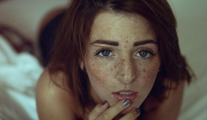 open mouth, painted nails, brunette, face, blue eyes, women, André Josselin, lying on front, model, finger on lips, looking at viewer, freckles