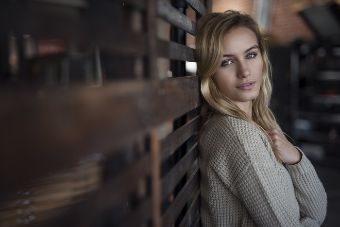 Woman with blonde hair wearing a sweater