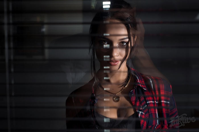 Anastasia Rozhdestvenskay behind blinds