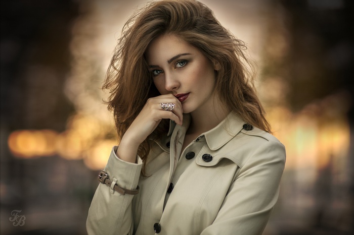 Woman with blonde hair wearing a trench coat