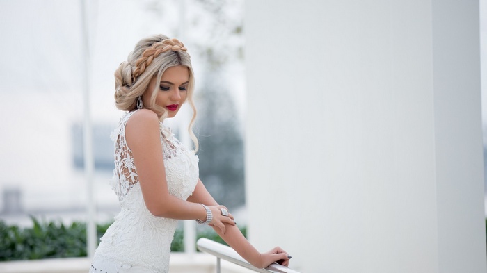 Woman with blonde braids in a white dress