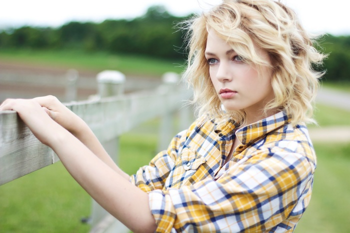 Hannah Duggan Poses by a Wooden Fence