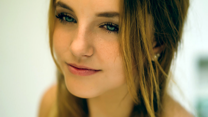 Young woman with blue eyes and freckles