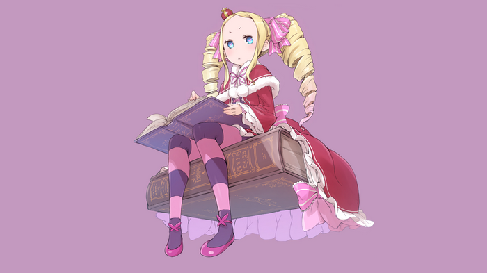 Beatrice reading a book while sitting on books