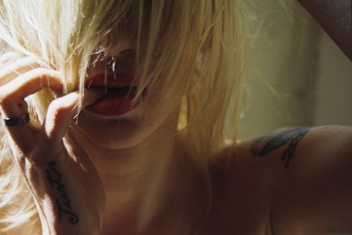 Natasha Legeyda with blonde hair and a piercing