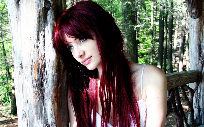 Susan Coffey in a white top in the woods