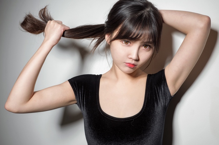 Asian woman pulling her hair