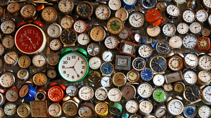 A large collection of analog alarm clocks