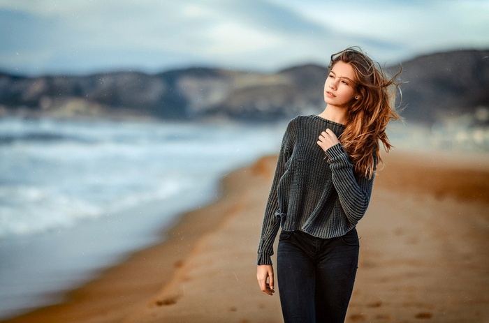 Young woman walking on a beach