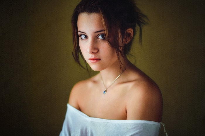 Portrait of a young woman with a necklace