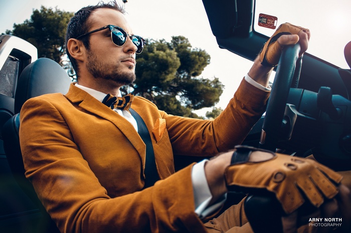 Man in suit driving a BMW Z4