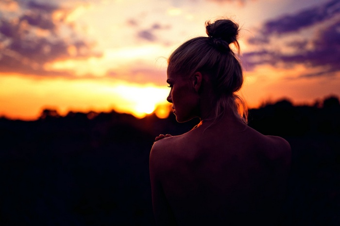 Woman with hair bun at sunset