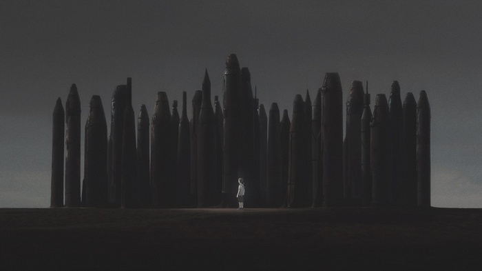 Child standing among tall stone pillars