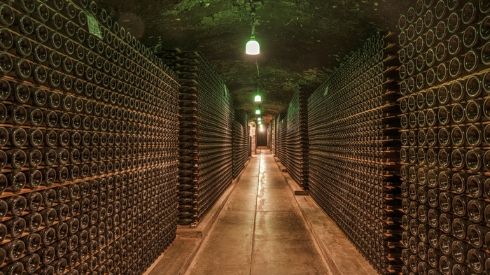 Wine cellar hallway with stacked bottles in California