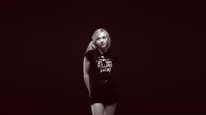 Emily Kinney in a black t-shirt and shorts