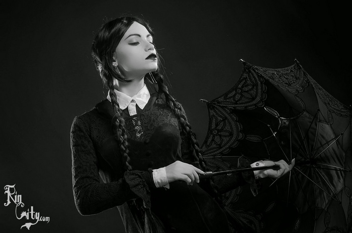 Wednesday Addams cosplay with black umbrella