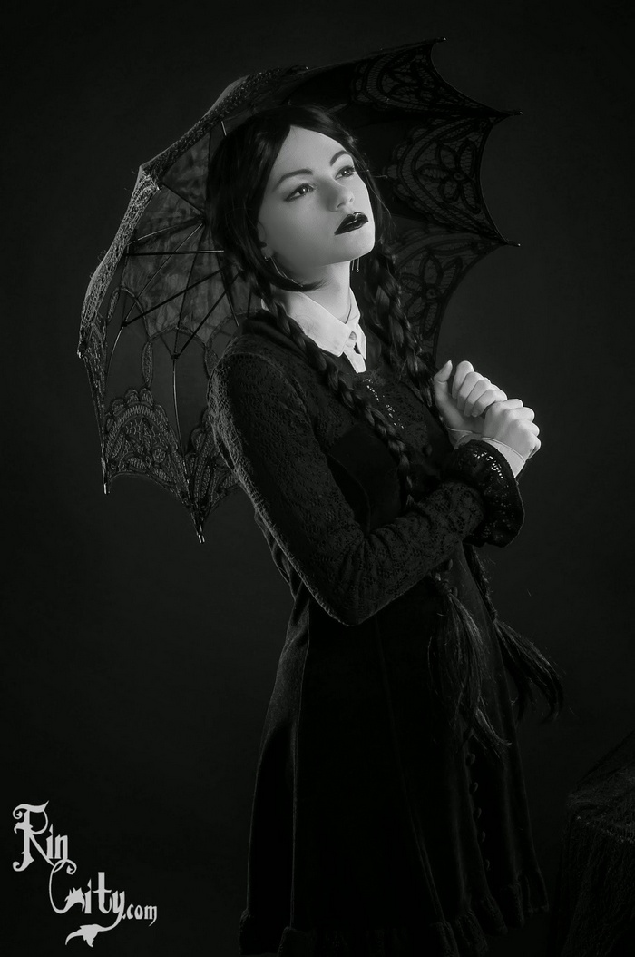 Wednesday Addams cosplay with black umbrella