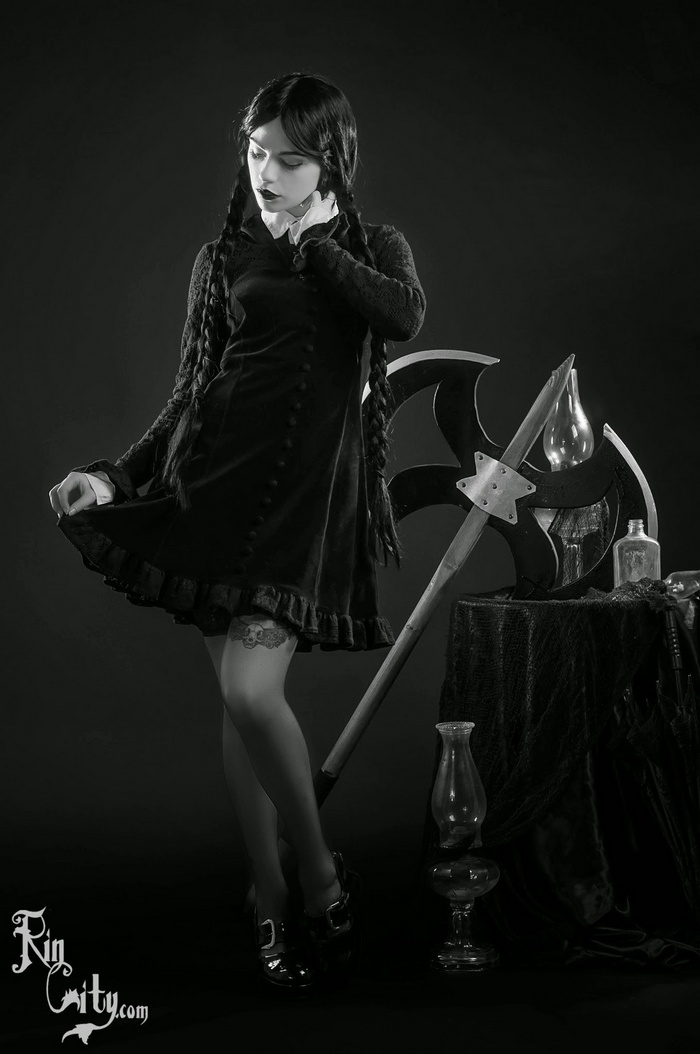 Wednesday Addams cosplay with axe and lamps
