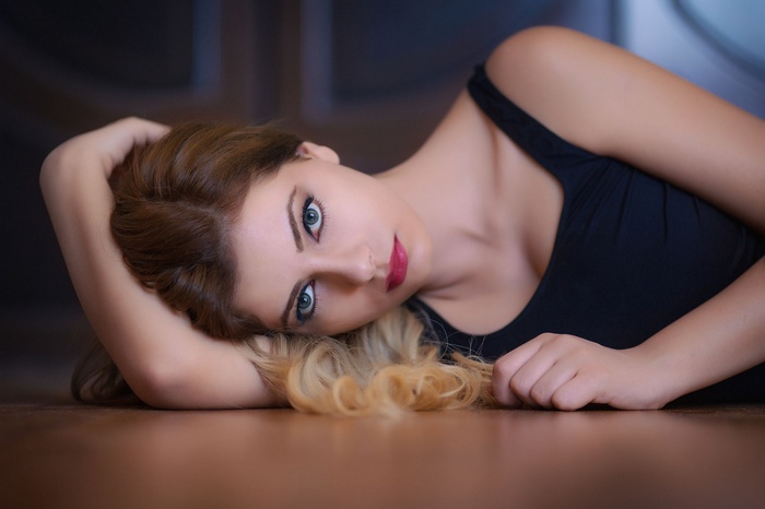 Woman with blonde hair lying on the floor