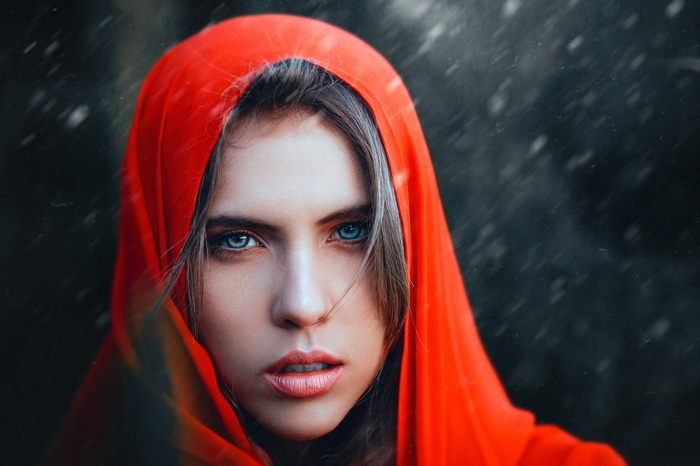 Woman with blue eyes wearing a red hood