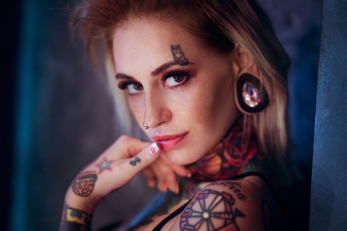 Woman with tattoos and piercings by Ivan Gorokhov