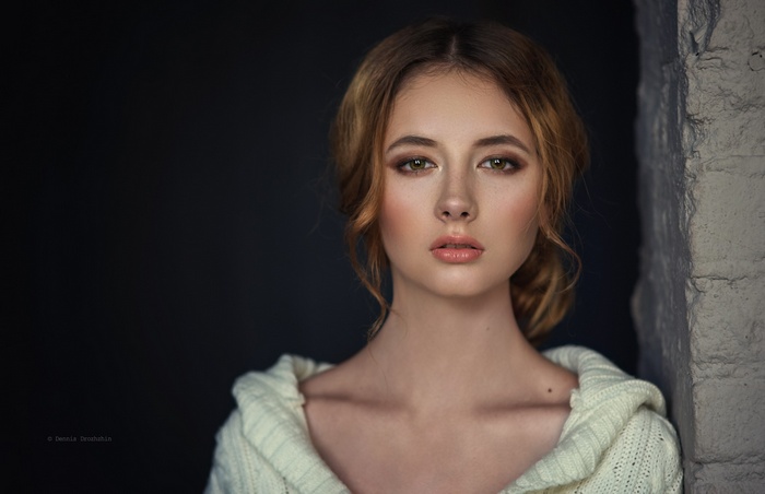 Portrait of a young woman with freckles and blonde hair