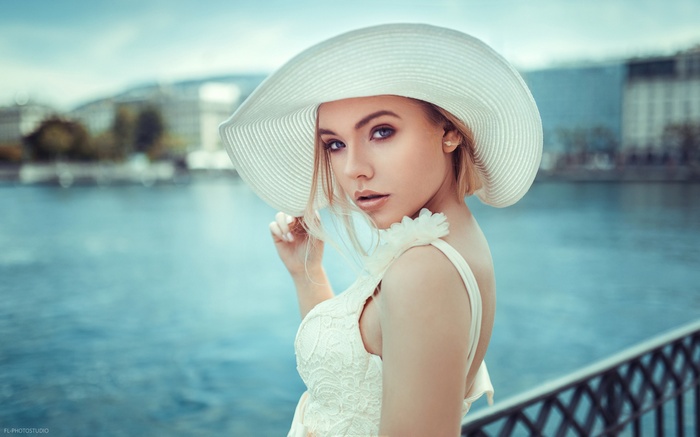 Anna Maradan wearing a white hat and dress outdoors