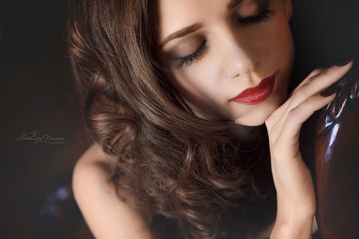 Woman with dark hair and red lipstick