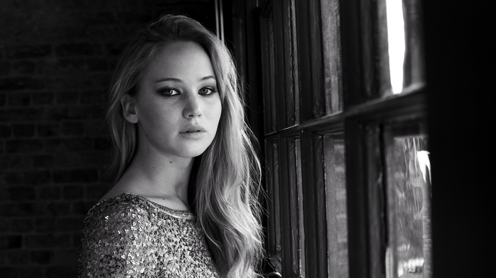 Jennifer Lawrence in a sequined dress by a window