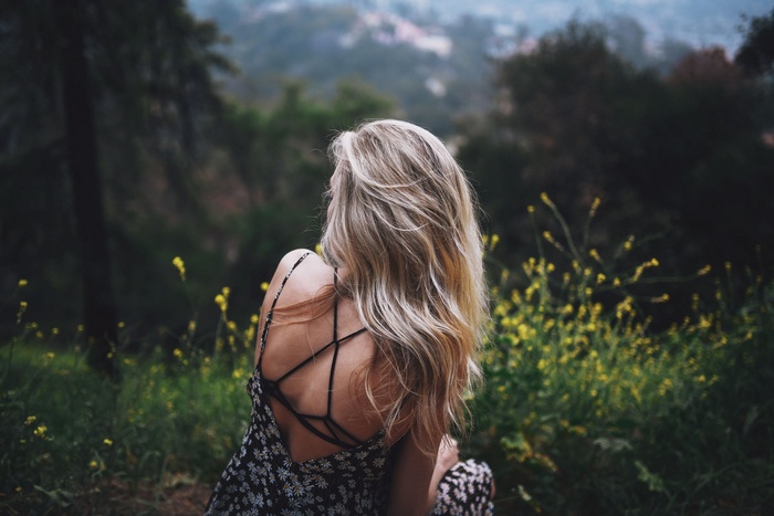 Woman in a floral dress in a forest
