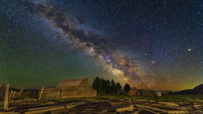 Milky Way over a rustic barn at night