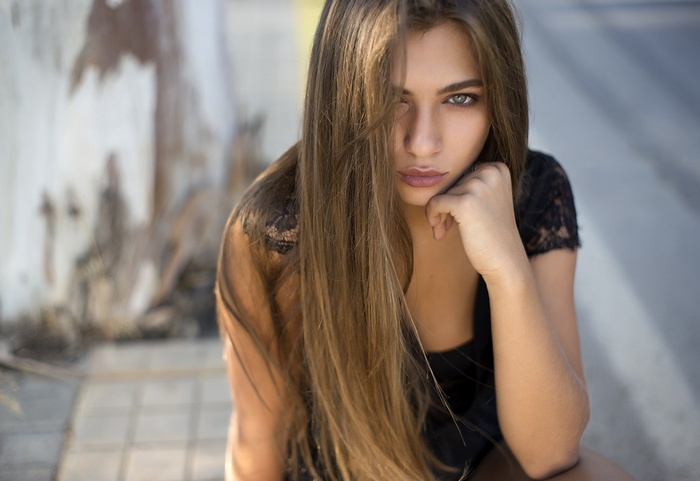 Portrait of a woman with long brown hair and blue eyes
