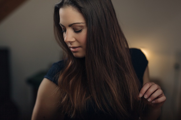 Woman with long brown hair indoors