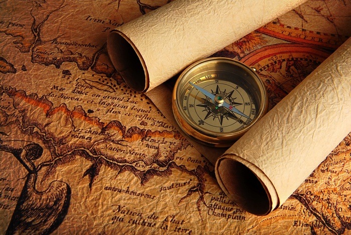 Antique map with compass and rolled scrolls